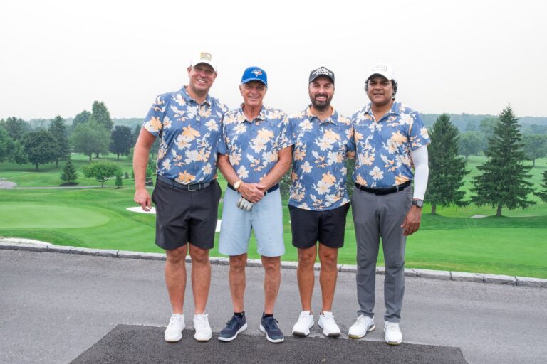Foursome in matching floral shirts on the tee